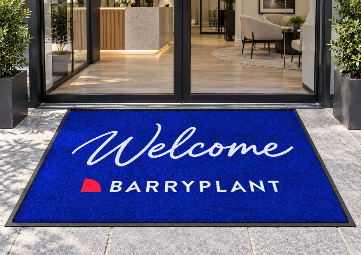 Royal blue logo mat reading Welcome above the Barry Plant logo