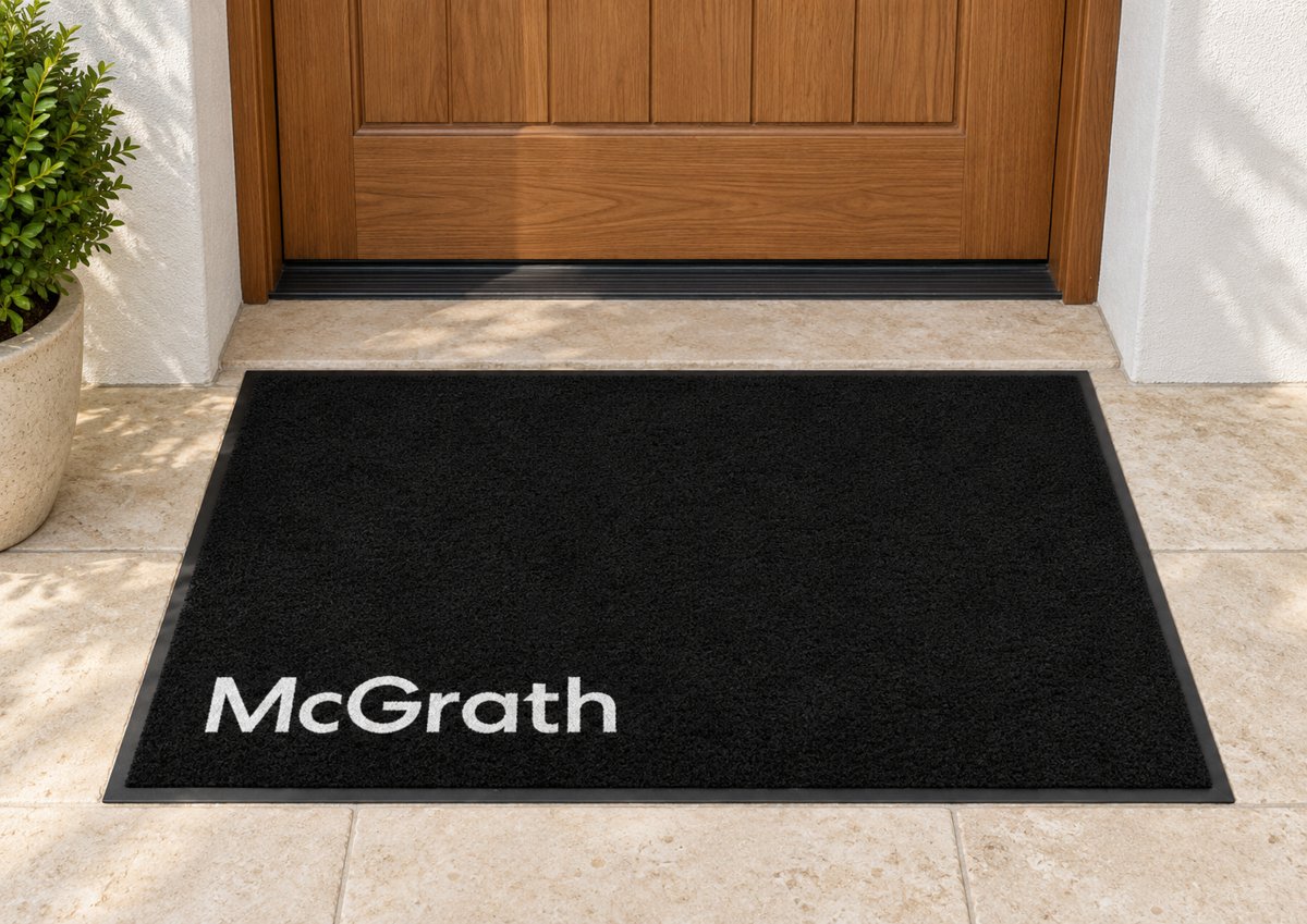 Black logo mat with the McGrath logo in the lower corner