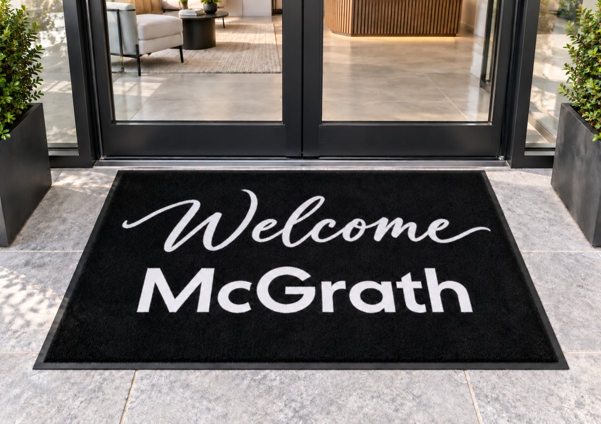 Welcome McGrath custom logo mat at an office entrance
