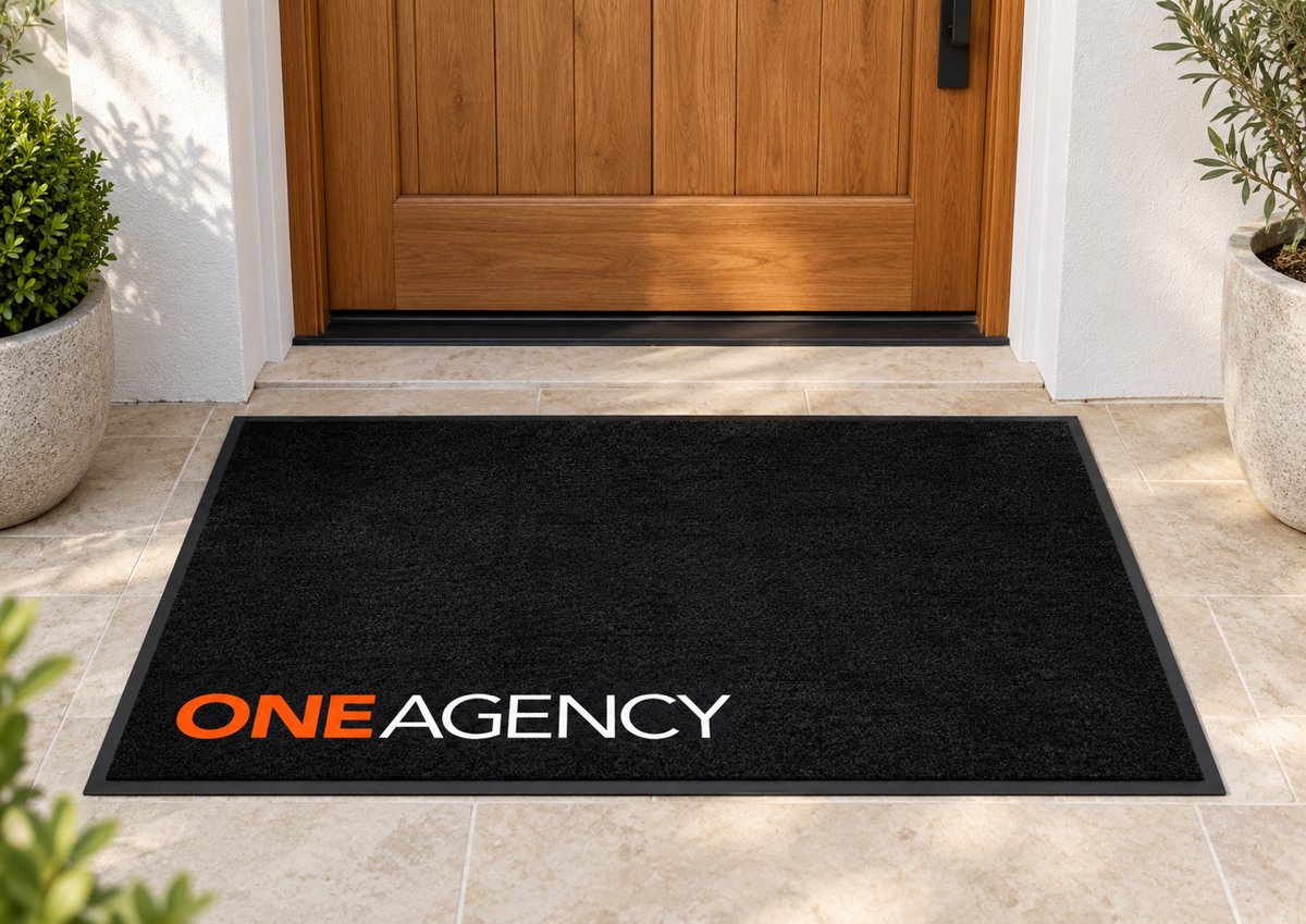 Black logo mat with the One Agency logo in the corner