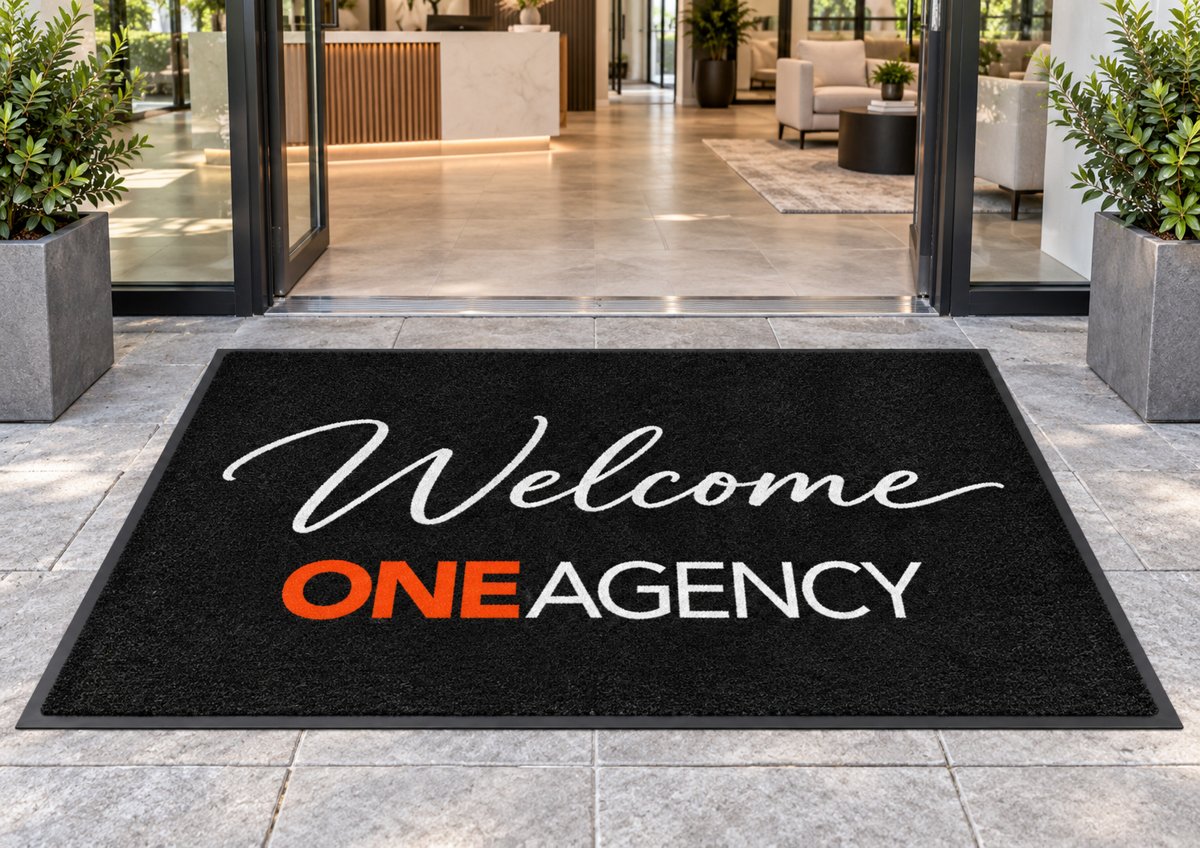 Welcome One Agency logo mat at an office entrance