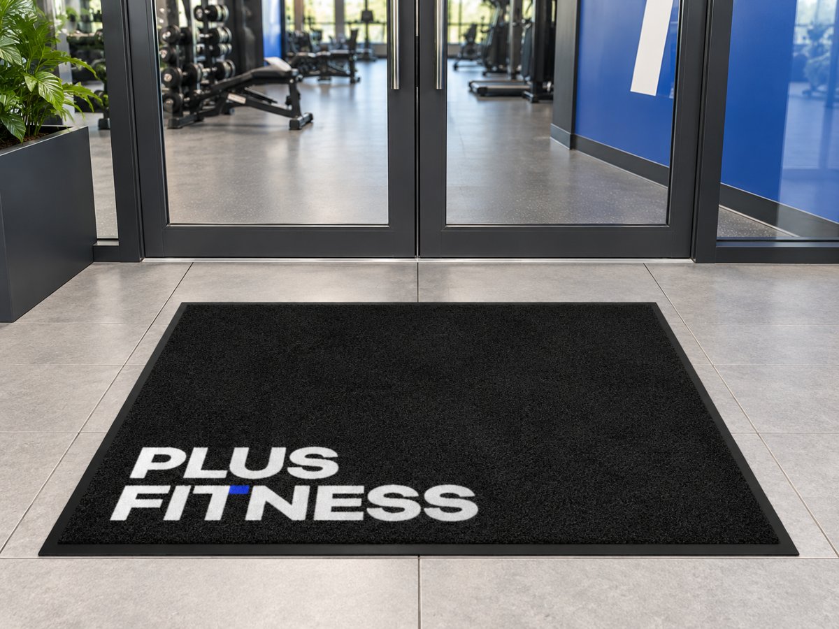 Black mat with the Plus Fitness logo in the corner